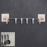Stainless steel utensil hanger rail with 2 magic stickers and 6 hooks installed on kitchen wall