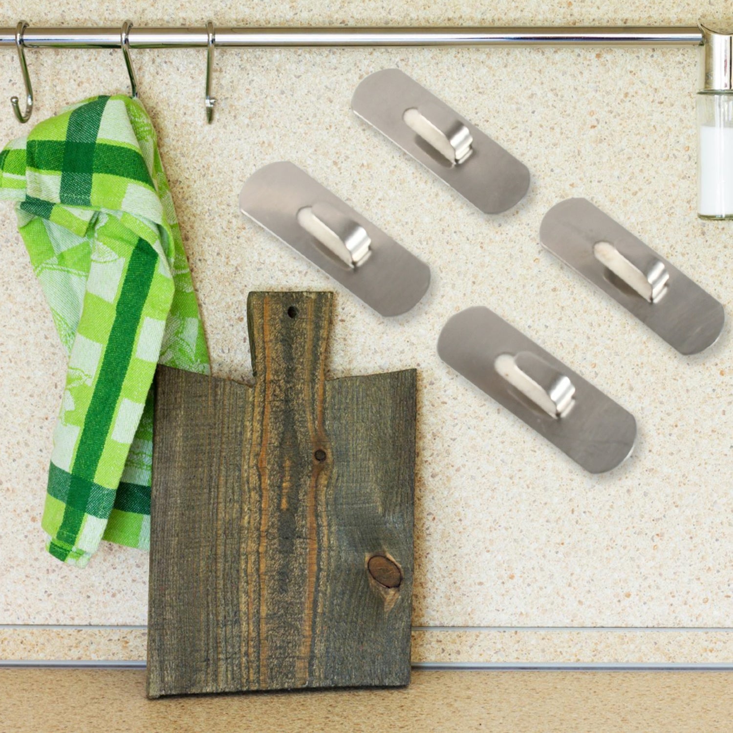 Stainless steel self-adhesive hooks in silver on white background