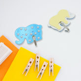 White self-adhesive hook on a tiled wall, demonstrating strong grip.