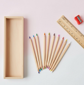 Colorful wooden pencils in a set with a pencil box, ruler, and sharpener.