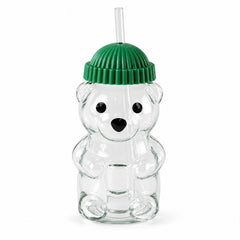 A clear bear-shaped glass sipper with a green ribbed lid and a transparent straw on a white background.