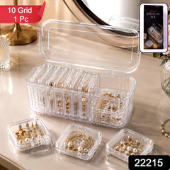 Transparent jewelry organizer with removable grid cases and open section for larger pieces.