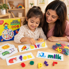 A woman and a young girl smiling while playing with colorful letter pieces on word puzzle cards at a wooden table.
