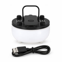 A white and black portable night light with a handle and a coiled USB charging cable on a white background.