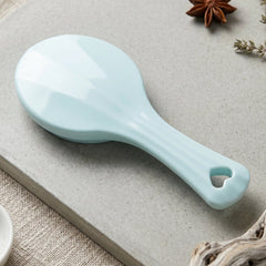Detail view of the manual paddle massager showing smooth steel balls.