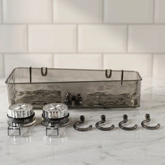 A clear grey plastic caddy, two silver suction cups, and four grey hooks are arranged on a white marble surface.