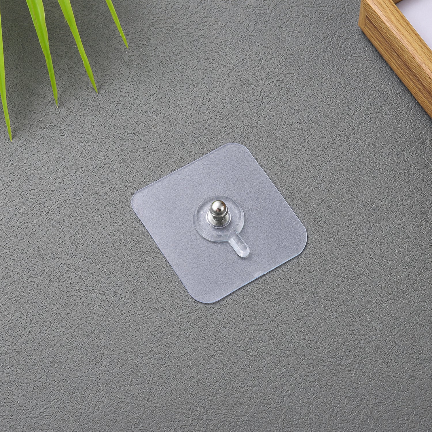 Transparent adhesive wall hook for frames