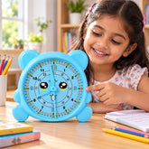 A young girl points at a light blue bear-shaped learning clock with a smiling face and large numbers.