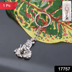 Close-up of Bal Krishna Makhan Chor keychain held in hand