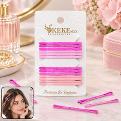 A pack of sixteen pink and magenta bobby pins on a card, with a model wearing one pin in her hair.