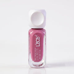 A clear glass bottle of mauve nail polish with a white square cap stands upright on a white background.