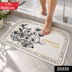 A half-round white mat with black botanical print and a golden quote, with a person's feet stepping on it, in a bathroom.