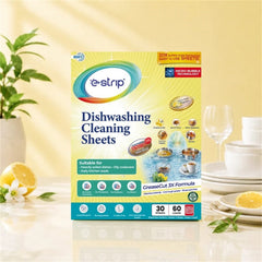 A box of e-strip dishwashing cleaning sheets on a counter with lemons, white flowers, and dishware.