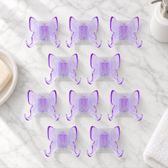 Ten self adhesive butterfly wall hooks arranged neatly on a surface