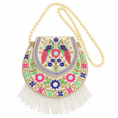 A white embroidered sling purse with colorful peacock and floral patterns, mirror work, and a long beaded strap.