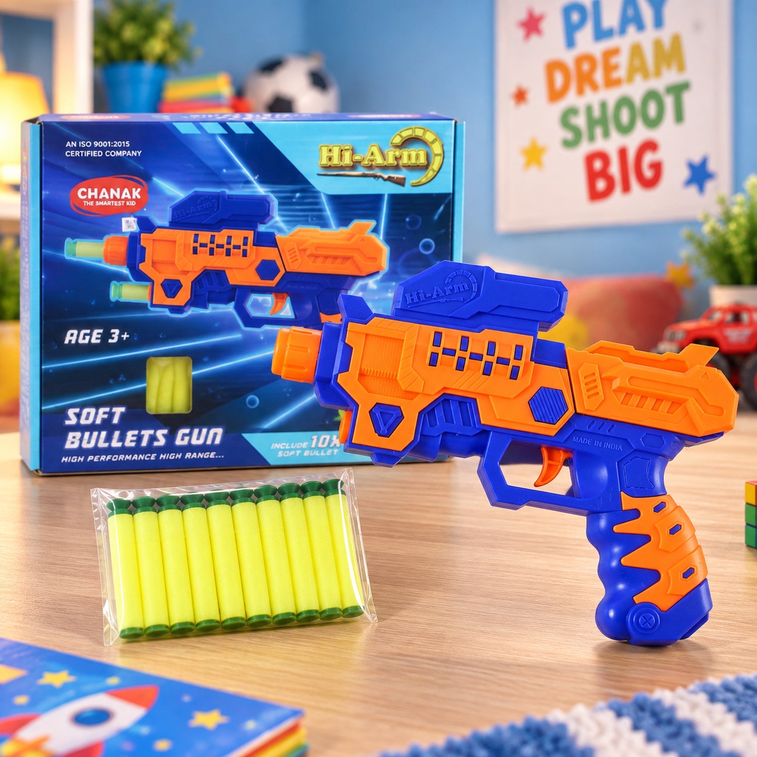 An orange and blue toy gun with a box of soft bullets on a wooden table, next to its packaging.