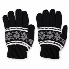 A pair of black knitted gloves with a white and gray snowflake pattern laid flat on a white surface.