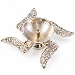 A shiny silver swastik-shaped diya with an empty oil reservoir is presented on a clean white background.