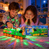 Two children playing with a bright green battery-operated toy train that emits colorful flashing lights on a patterned rug.