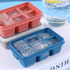Blue 6-grid silicone ice tray filled with water