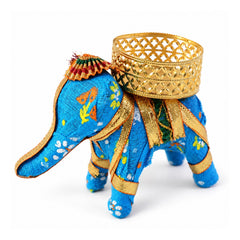 A vibrant blue fabric elephant candle holder with a gold lattice cup, isolated against a white background.