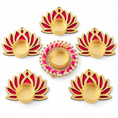 Overhead view of six golden and magenta lotus-shaped tealight holders with unlit candles on a white background.
