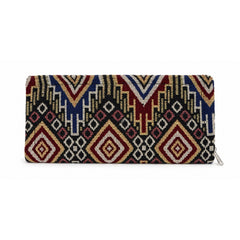 A closed rectangular clutch wallet with a vibrant geometric pattern in red, blue, yellow, and black, against a white