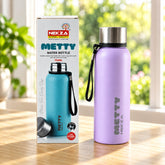 A light purple Metty water bottle with a silver cap and black strap stands next to its product box on a wooden table.