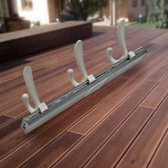 Coat rack installed on wall with jackets and scarves hanging