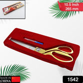 Close-up of sharp golden tailoring scissors cutting fabric
