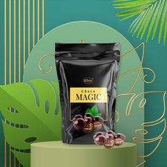 Black "Choco Magic" pouch surrounded by green tropical leaves and gold geometric shapes on a light green pedestal.