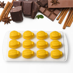 fruit-shaped ice cubes in glass and silicone mold in background