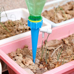 Adjustable self-watering plant spike inserted in soil