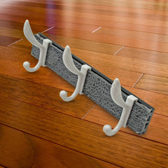Side view of wall mounted coat hanger rack with items hanging