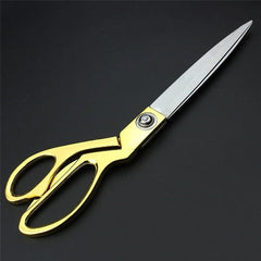 Top view of golden tailoring scissors with stainless steel blades