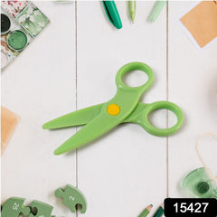 Child using colorful plastic safety scissors