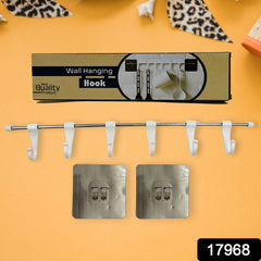 Close-up of stainless steel utensil rail with plastic hooks attached