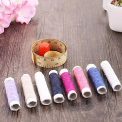 Sewing box with neatly arranged spools of thread and notions