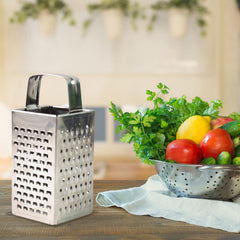 Stainless steel vegetable grater with multiple surfaces