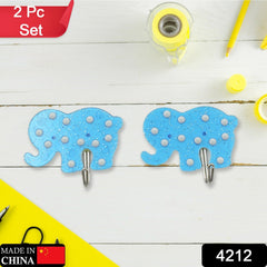 Two self-adhesive hooks holding kitchen utensils like a ladle and spatula.