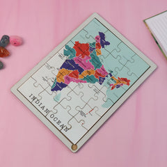 Child's hands placing a state piece on the India map puzzle