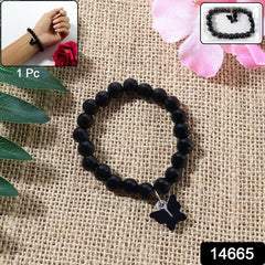 Close-up of butterfly charm on beaded bracelet