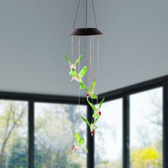 Multicolor LED illuminated hummingbird wind chime at night