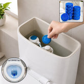 A hand drops a blue toilet cleaner tablet into a toilet tank, with an inset showing blue water in the bowl.