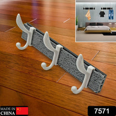 Close-up of metal hooks on solid wood coat rack