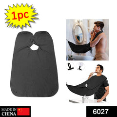 Beard grooming bib attached to mirror with suction cups