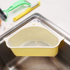 Triangular sink caddy holding sponge & brush on kitchen sink