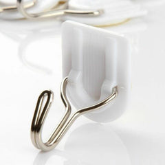 Close-up of white plastic adhesive hook for hanging towels.