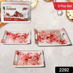 Three plastic serving trays of different sizes, arranged on a kitchen counter.
