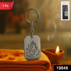 Ganesh Bless metal keychain held in hand